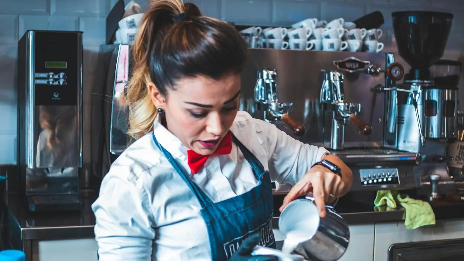 woman pouring liquid on mug